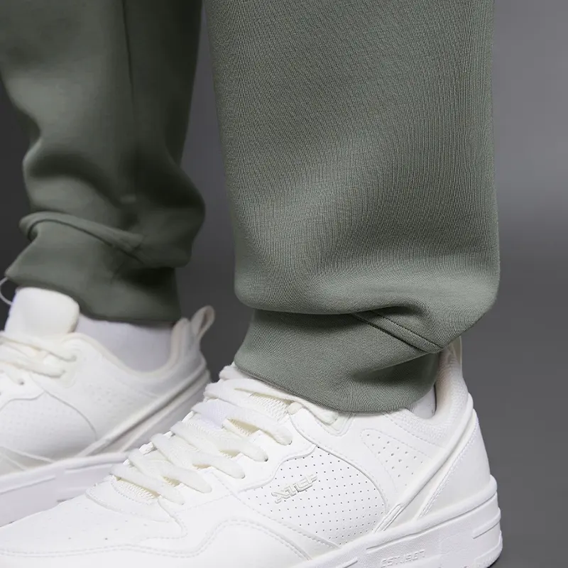 MZ-MWP002 | Wholesale Men's Joggers: 300G Brushed Air-Layer Fabric & Secure Back Zip Pocket - Iron Mountain Green - muzyoga 4 Detailed view of the tapered leg cuffs for a sharp look.