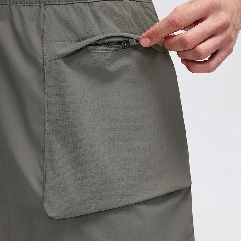MZ-027 | Wholesale Lightweight Utility Cargo Skirt: Water-Repellent & Built-in Liner - Coal Dust - muzyoga 5 Detailed view of dual-side cargo pockets with secure top zippers.