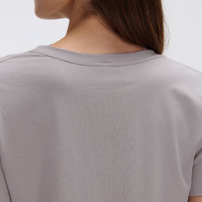 Custom Women's V-Neck Lyocell-Cotton T-Shirt | MZ-087 7 Detailed view of the fabric flexibility during back stretches.