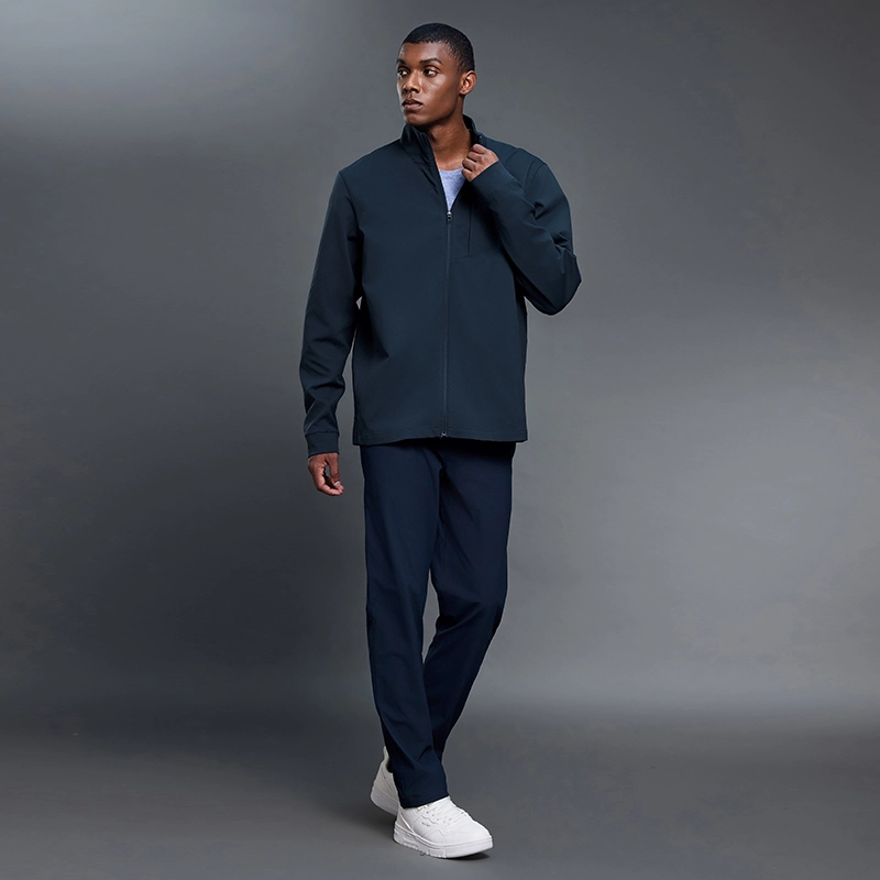 MZ-MJ001 | Wholesale Men's Full-Zip Performance Jacket: 200G Fine-Ribbed Tech Fabric & Secure Zip Pockets - Deep Sea Blue - muzyoga 7 Full-body lifestyle shot of man wearing MZ-MJ001 in outdoor training.