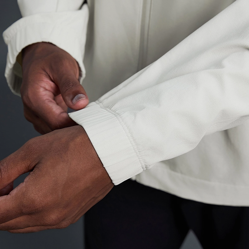 MZ-MJ003 | Wholesale Men's Ultra-Light Windbreaker: 145G High-Performance Fabric & Underarm Ventilation - Bone White - muzyoga 5 Detailed view of the elasticized cuffs of the jacket.