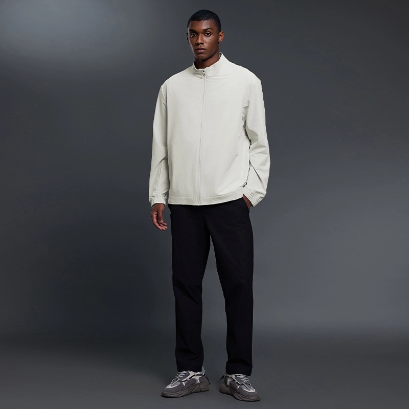 MZ-MJ003 | Wholesale Men's Ultra-Light Windbreaker: 145G High-Performance Fabric & Underarm Ventilation - Bone White - muzyoga 7 Man wearing Bone White MZ-MJ003 jacket in an outdoor setting.