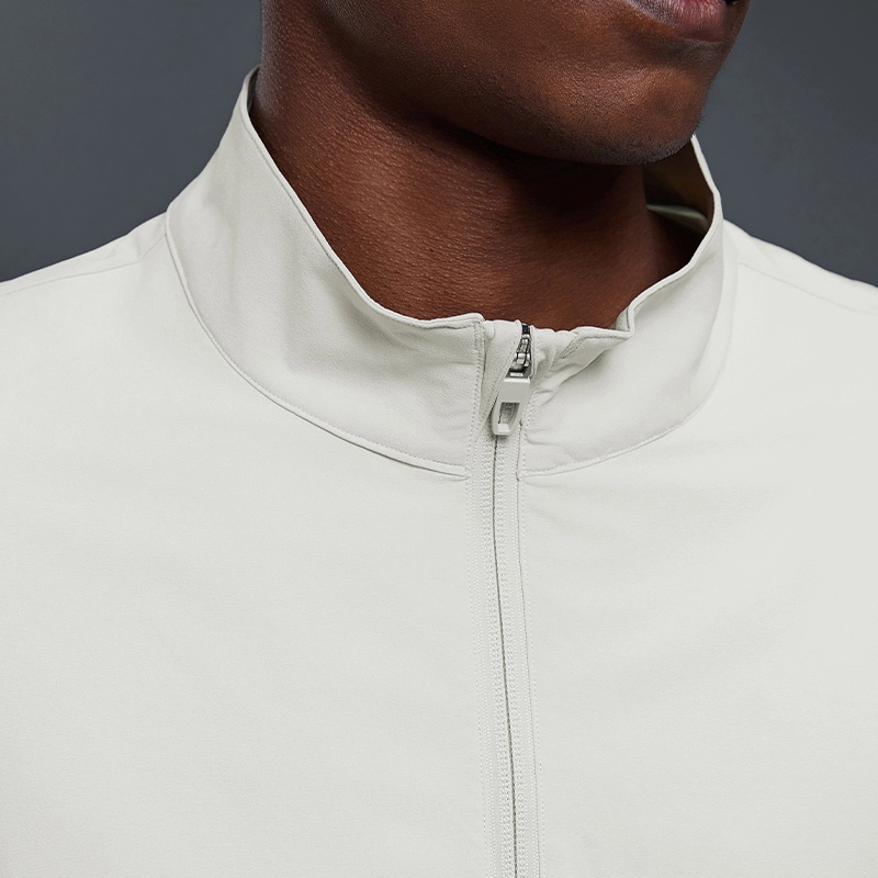 MZ-MJ003 | Wholesale Men's Ultra-Light Windbreaker: 145G High-Performance Fabric & Underarm Ventilation - Bone White - muzyoga 3 Detailed view of the structured stand-up collar on MZ-MJ003.