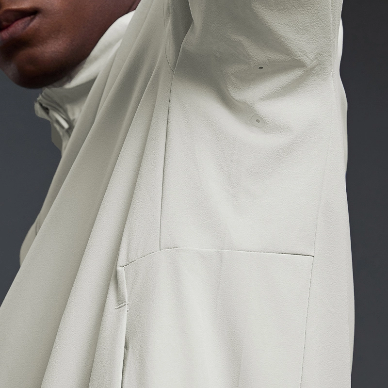 MZ-MJ003 | Wholesale Men's Ultra-Light Windbreaker: 145G High-Performance Fabric & Underarm Ventilation - Bone White - muzyoga 4 Close-up of the underarm ventilation vents for cooling.