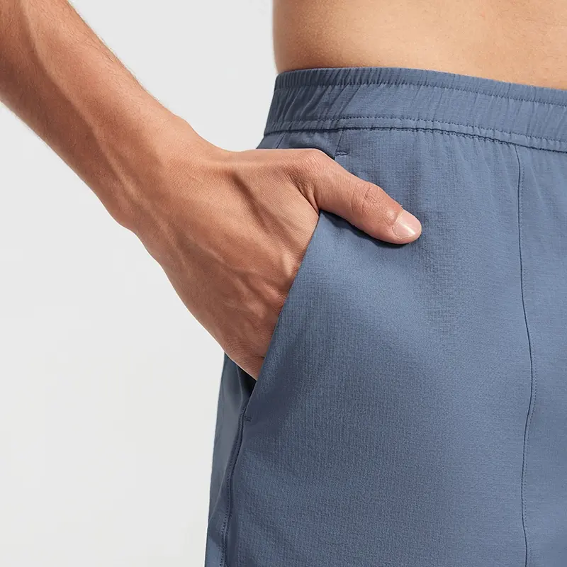 MZ-MS003 | Wholesale Men's Tech Casual Shorts: Water-Repellent 4-Way Stretch & Secure Zip Pocket - Washed Denim Blue - muzyoga 4 Detailed view of the deep side slant pockets for quick access.