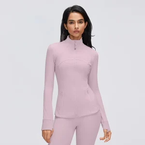 Front view of a women's slim fit full zip workout jacket in Porcelain Pink, showing the stand collar, contoured seams, zip pockets and thumbhole cuffs.