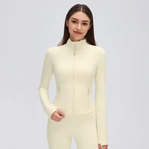 Front view of a Cream Yellow fitted full-zip workout jacket with stand collar, curved panel seams, zip pockets and thumbhole cuffs.