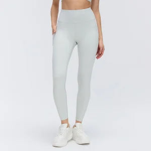 Front view of women's high-waisted workout leggings in Steam Gray with a wide waistband, fitted legs and side pockets.