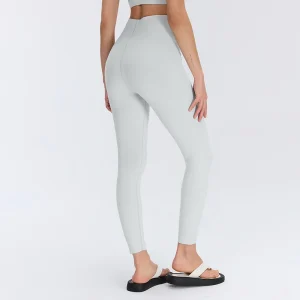 Rear three-quarter view of Steam Gray women's contour yoga leggings, showing the curved back seam construction and fitted legs.