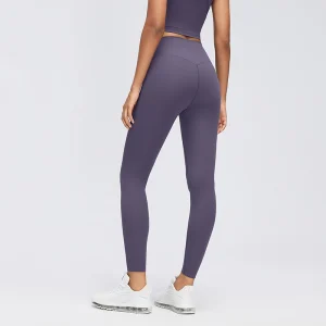 Rear three-quarter view of Deep Purple high-waisted leggings showing curved back seams and a fitted leg shape.