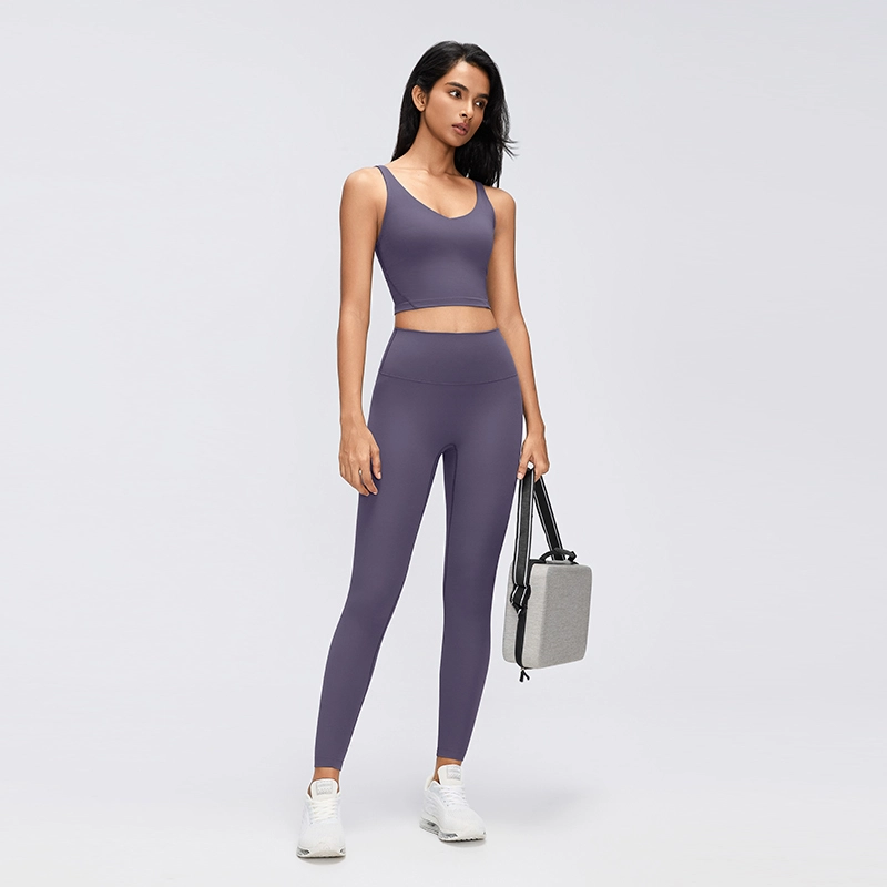 Women's High-Waisted No-Front-Seam Yoga Leggings 6 Model wearing Deep Purple high-waisted yoga leggings with a matching crop top in a full-length studio photograph.