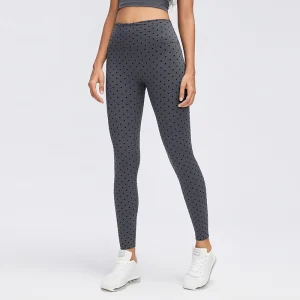 Front view of women's Gray flocked polka dot leggings with a wide high-rise waistband, fitted ankle-length legs and dark dotted pattern.