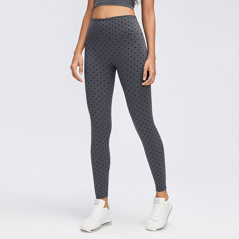 Women's High-Waisted Flocked Polka Dot Leggings 1 Front view of women's Gray flocked polka dot leggings with a wide high-rise waistband, fitted ankle-length legs and dark dotted pattern.