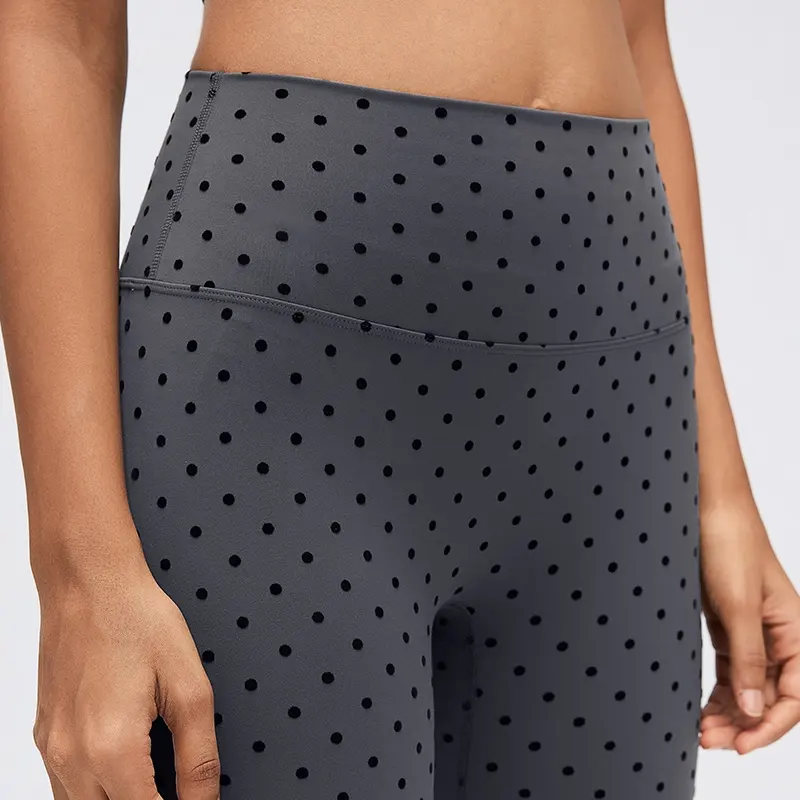 Women's High-Waisted Flocked Polka Dot Leggings 3 Close-up of Gray high-waisted polka dot leggings showing the wide waistband, clean center-front construction and small flocked dots.