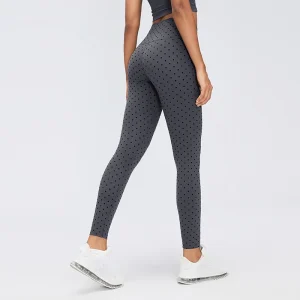 Flocked Polka Dot Leggings – Rear View Rear three-quarter view of Gray polka dot leggings showing the high waistband, curved back panel seams and fitted legs.
