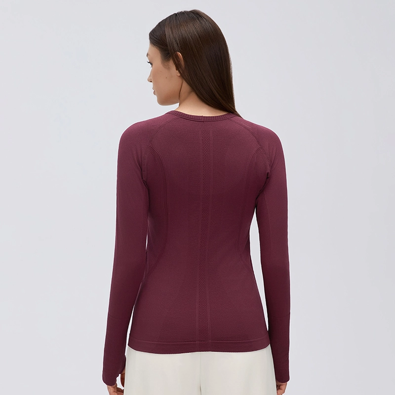 Women's Seamless Long Sleeve Workout Top with Thumbholes 2 Back view of a woman wearing a Burgundy seamless long sleeve workout top, showing the fitted silhouette and vertical textured knit panels.