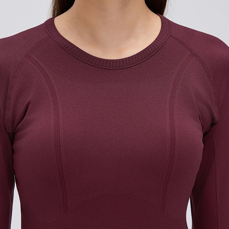 Women's Seamless Long Sleeve Workout Top with Thumbholes 4 Close-up of the ribbed crew neckline and front knit panels on a burgundy seamless long sleeve yoga top.