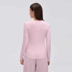 Women’s Modal Henley Long Sleeve Top – Pearl Pink Back View Back view of a pearl pink fitted modal long sleeve top showing the smooth back panel, long sleeves and rounded lower hem.