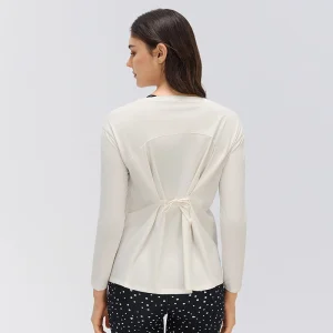 Adjustable Back Tie Long Sleeve Yoga Top – Rear View Rear view of an Ivory White long sleeve yoga top showing the adjustable center-back tie, gathered fabric and curved upper-back seam.