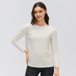 Front view of a women's tie-back long sleeve yoga top in Ivory White, featuring a boat neckline, relaxed fit and straight sleeves.