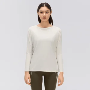 Front view of a women's relaxed fit boat neck long sleeve yoga top in Ivory White, showing dropped shoulders, straight sleeves and a loose-fitting body.