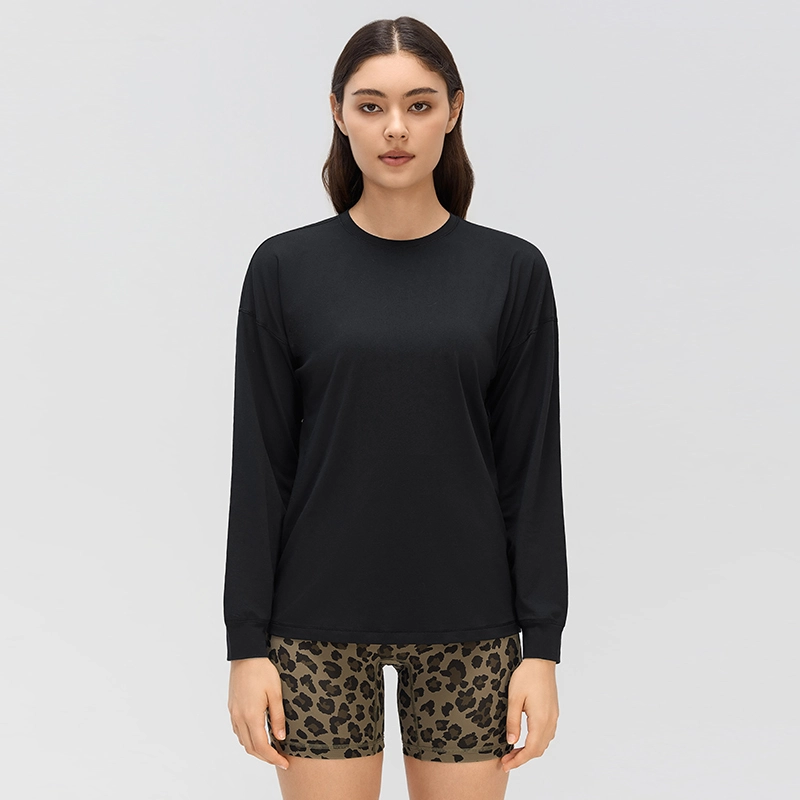 Women's Relaxed Fit Crew Neck Long Sleeve Top with Cuffed Sleeves 1 Front view of a women's black crew neck long sleeve yoga top with dropped shoulders, a relaxed fit and banded cuffs.