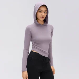 Front view of a women's Hibiscus Purple fitted hooded long sleeve top with side waist ruching, raglan-style sleeves and a curved hem.