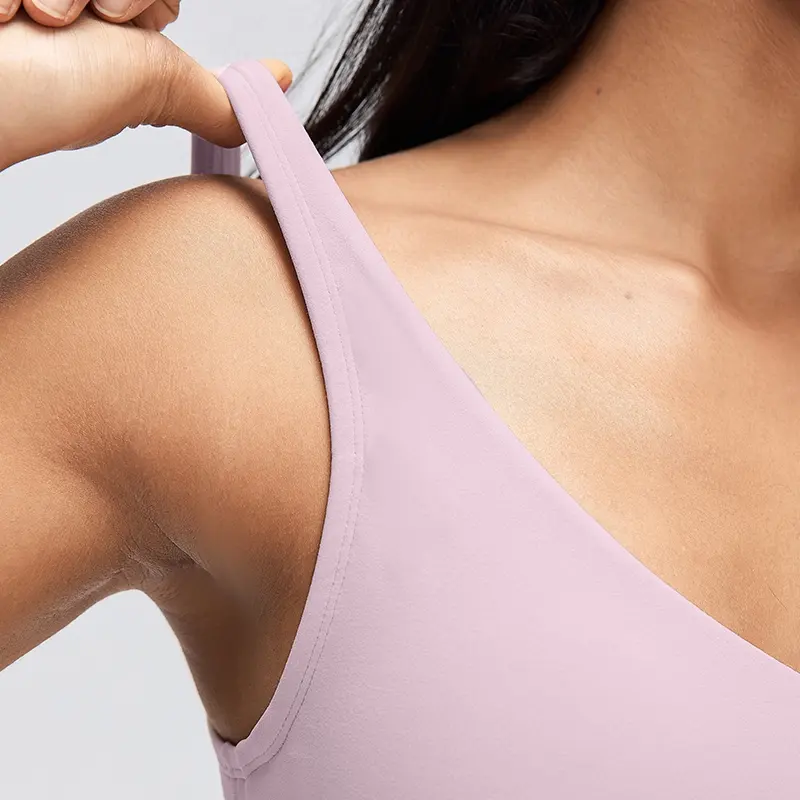 Women's V-Neck Longline Sports Bra with Scoop Back 3 Close-up of the wide shoulder strap and finished armhole edge of a Porcelain Pink V-neck yoga bra.