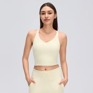 Front view of a model wearing a Cream Yellow V-neck cropped yoga tank top with broad shoulder straps and a fitted silhouette.