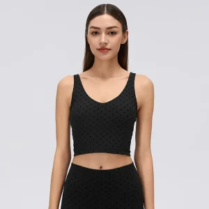 Front view of a black flocked polka dot padded crop tank top with a V-neckline, wide shoulder straps and fitted silhouette.