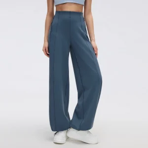 Front view of women's wide leg track pants in Steel Blue, showing a high-rise waistband, relaxed legs and vertical seam detailing.