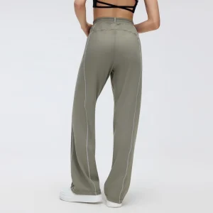 Women’s Straight-Leg Track Pants – Back View Back view of Warm Taupe Gray track pants showing the elasticized rear waistband, hanging loop, rear seam construction and contrast stitching along both legs.